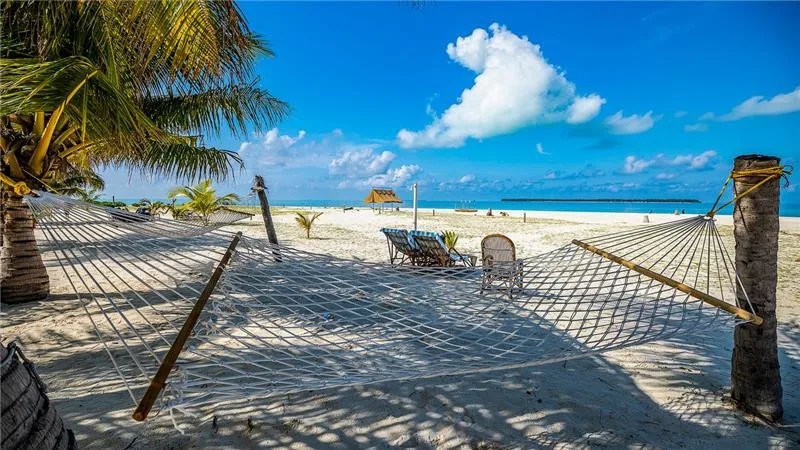Relaxing hammock on white sand beach at Thinnakara Island Lakshadweep