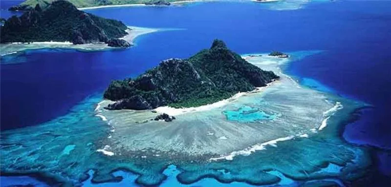 Aerial view of Kalpitti Island with surrounding sandbank and coral reef